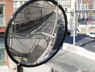 A photograph shows a curved mirror.